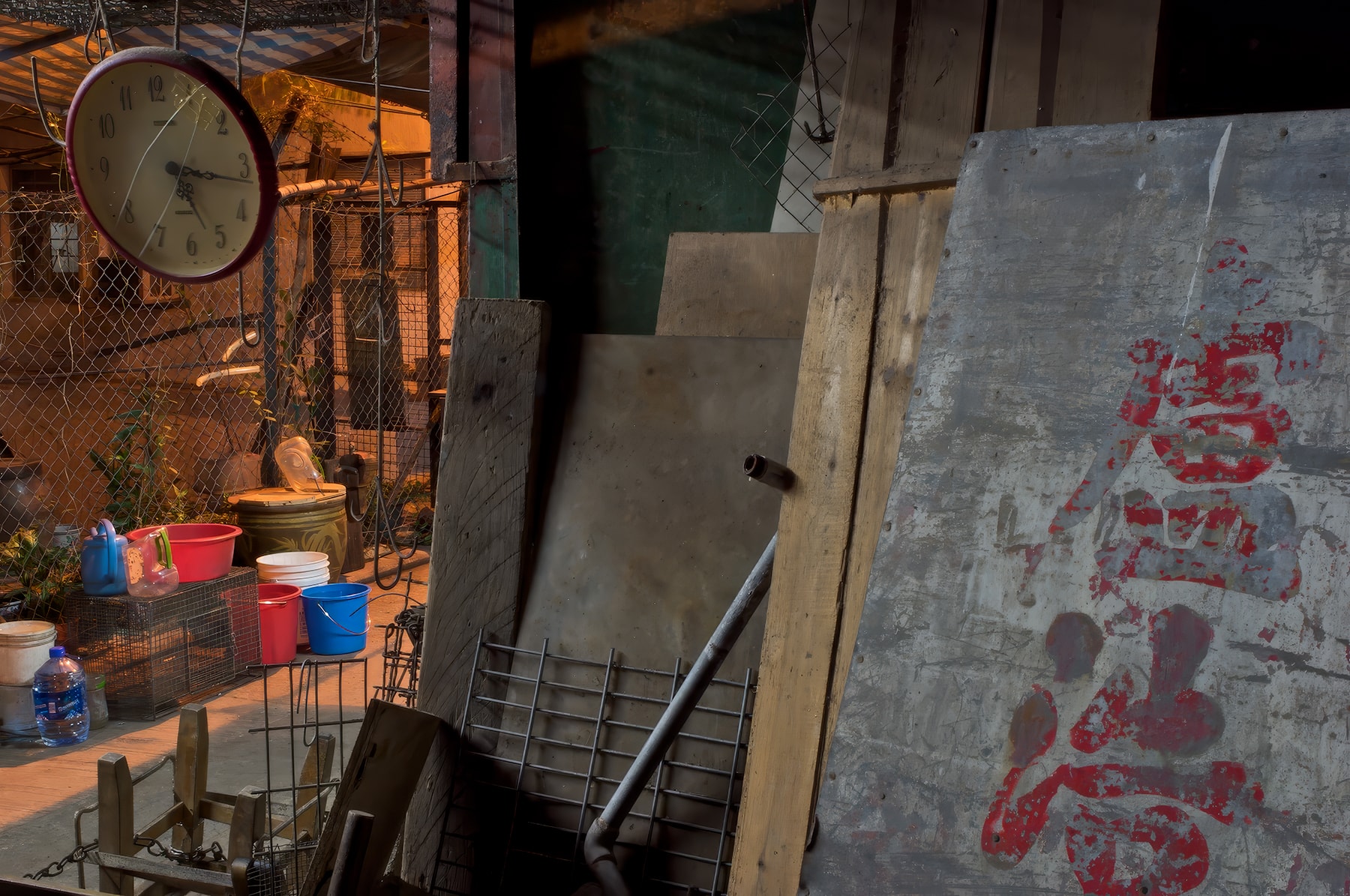 Industrial courtyard with clock, buckets and Chinese signage, Hong Kong