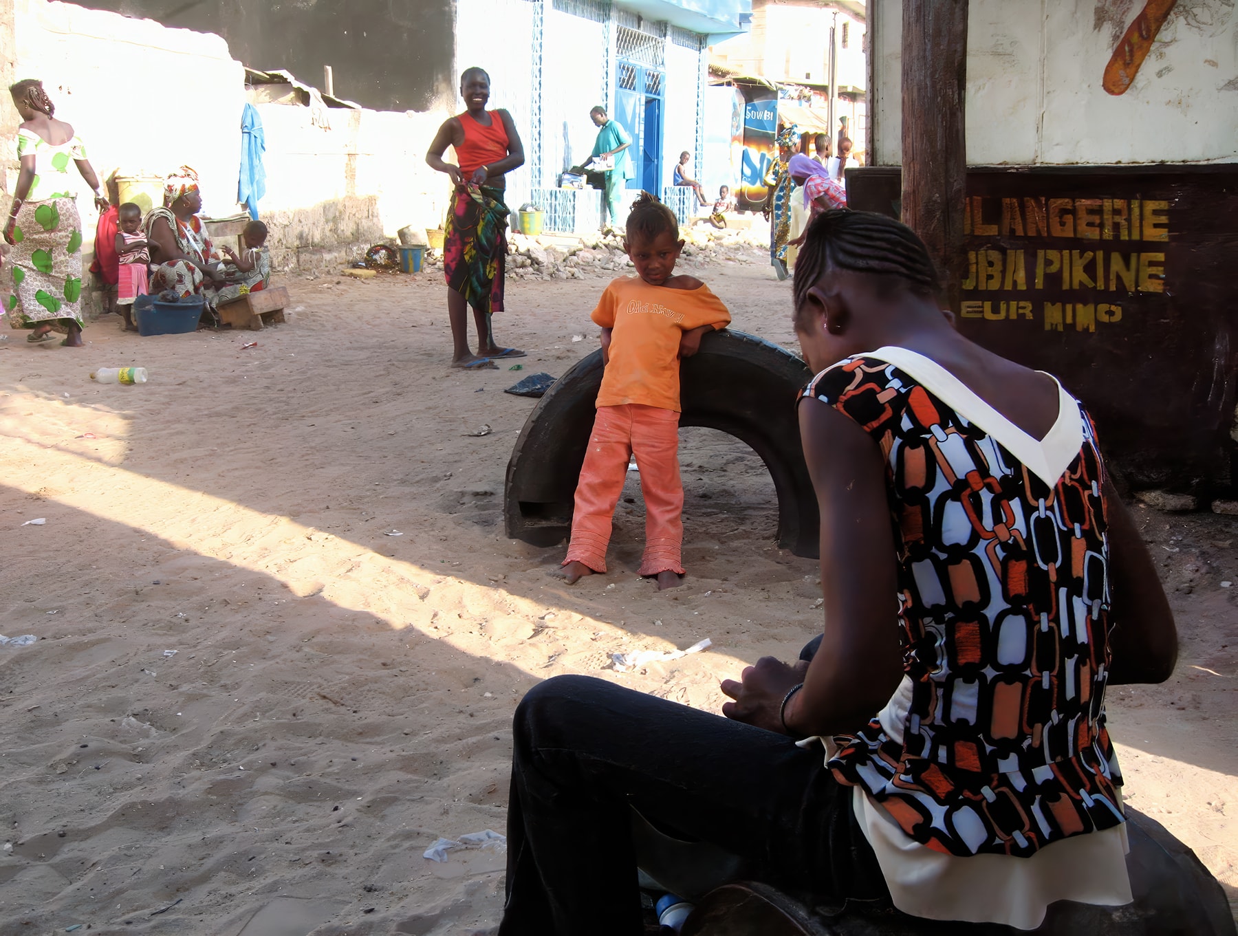 Street scene with child and tire, Dakar