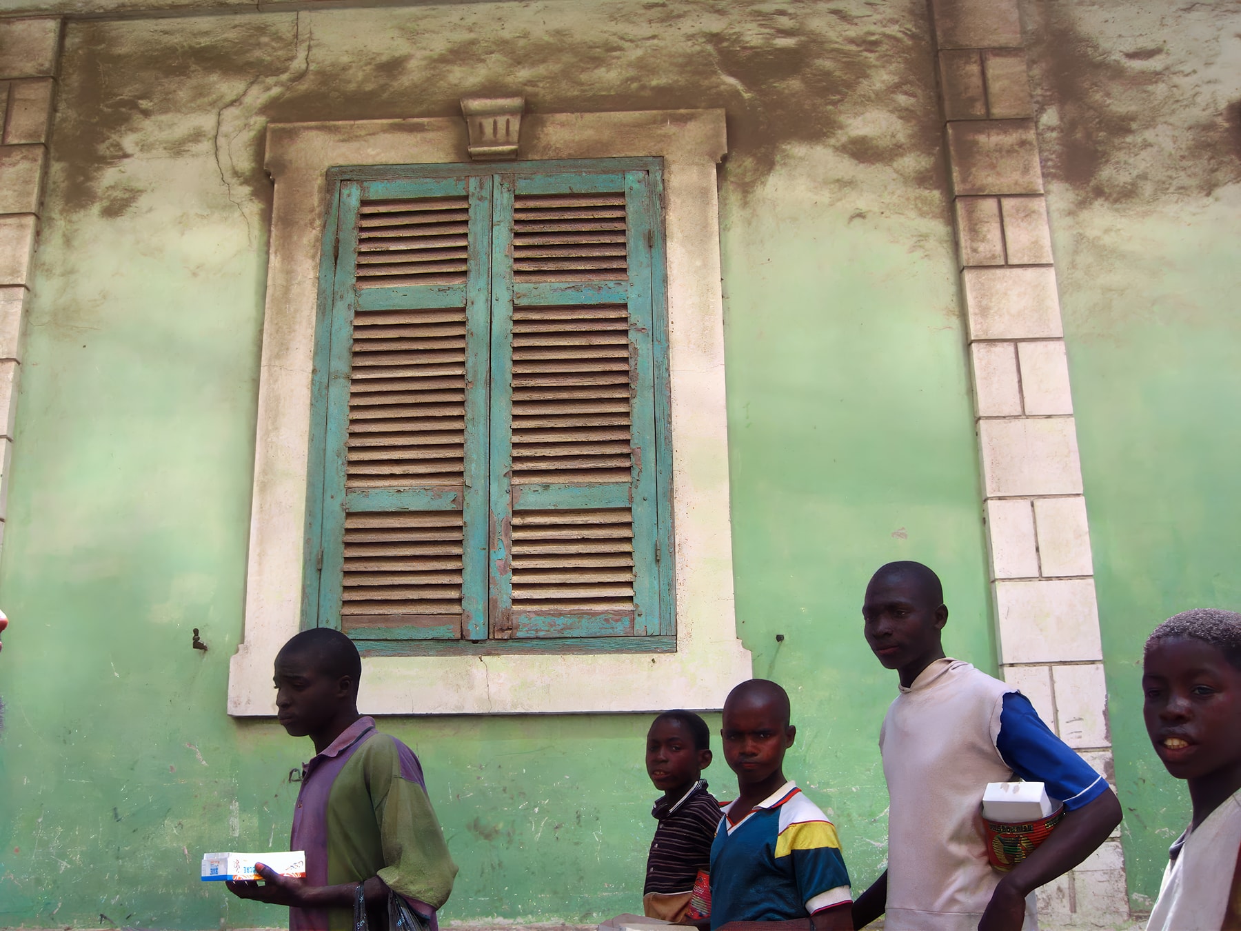 Group of people in front of green colonial building, Dakar